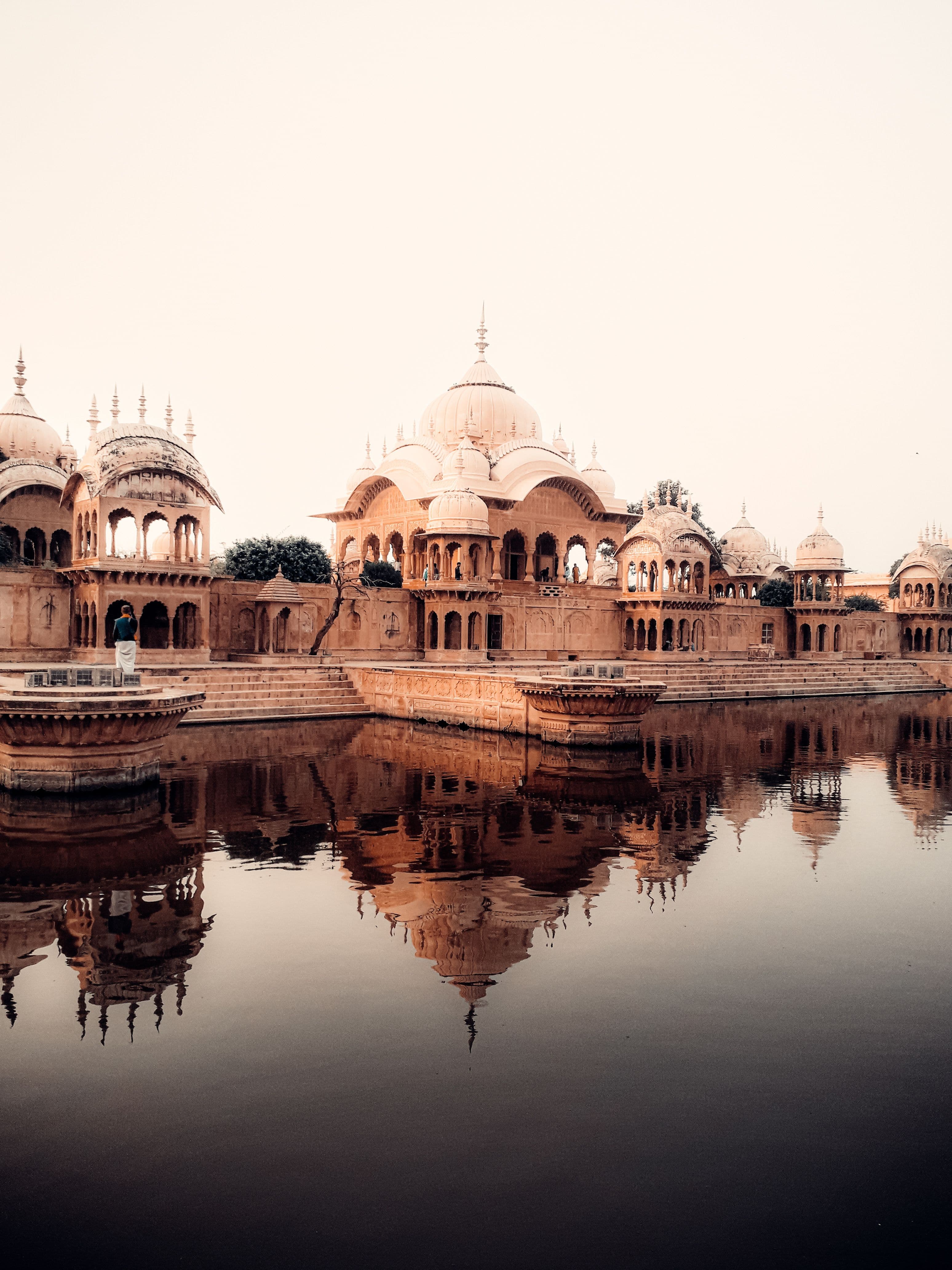The sandstone chhatris of Kusum Sarovar at Govardhan, mirrored in still water at dusk