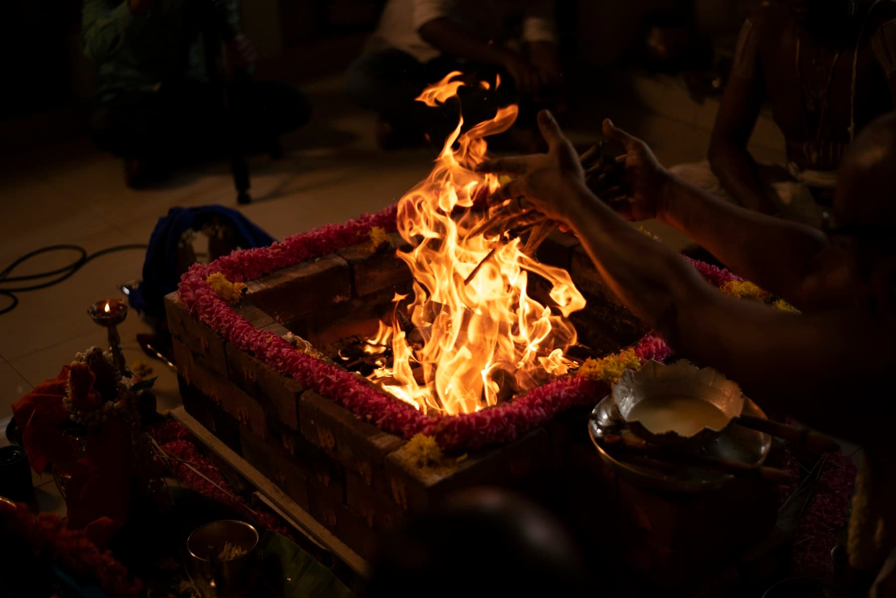 Fire burning in the havan kund, offerings at its edge