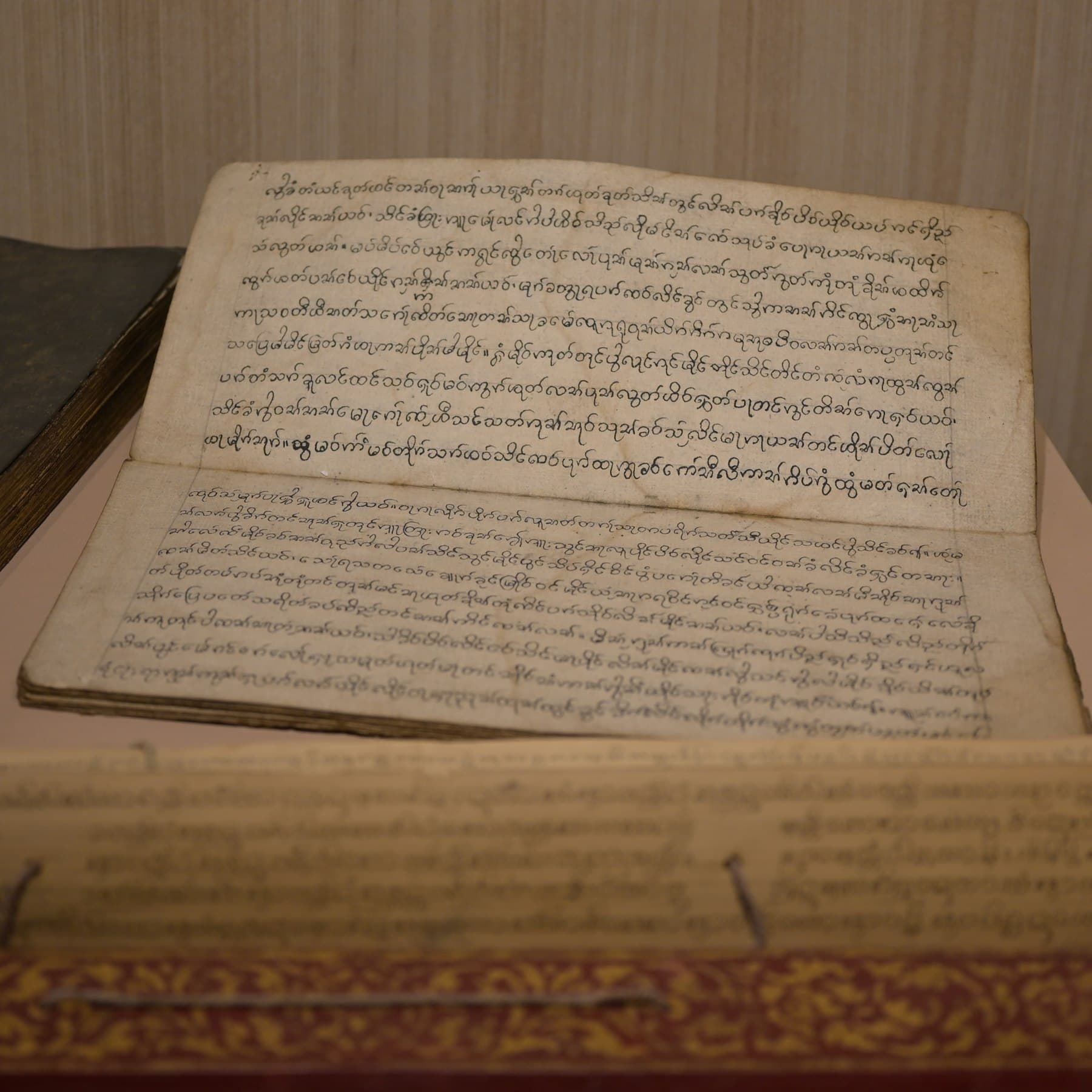 An old handwritten manuscript lying open, the kind a family horoscope is written in
