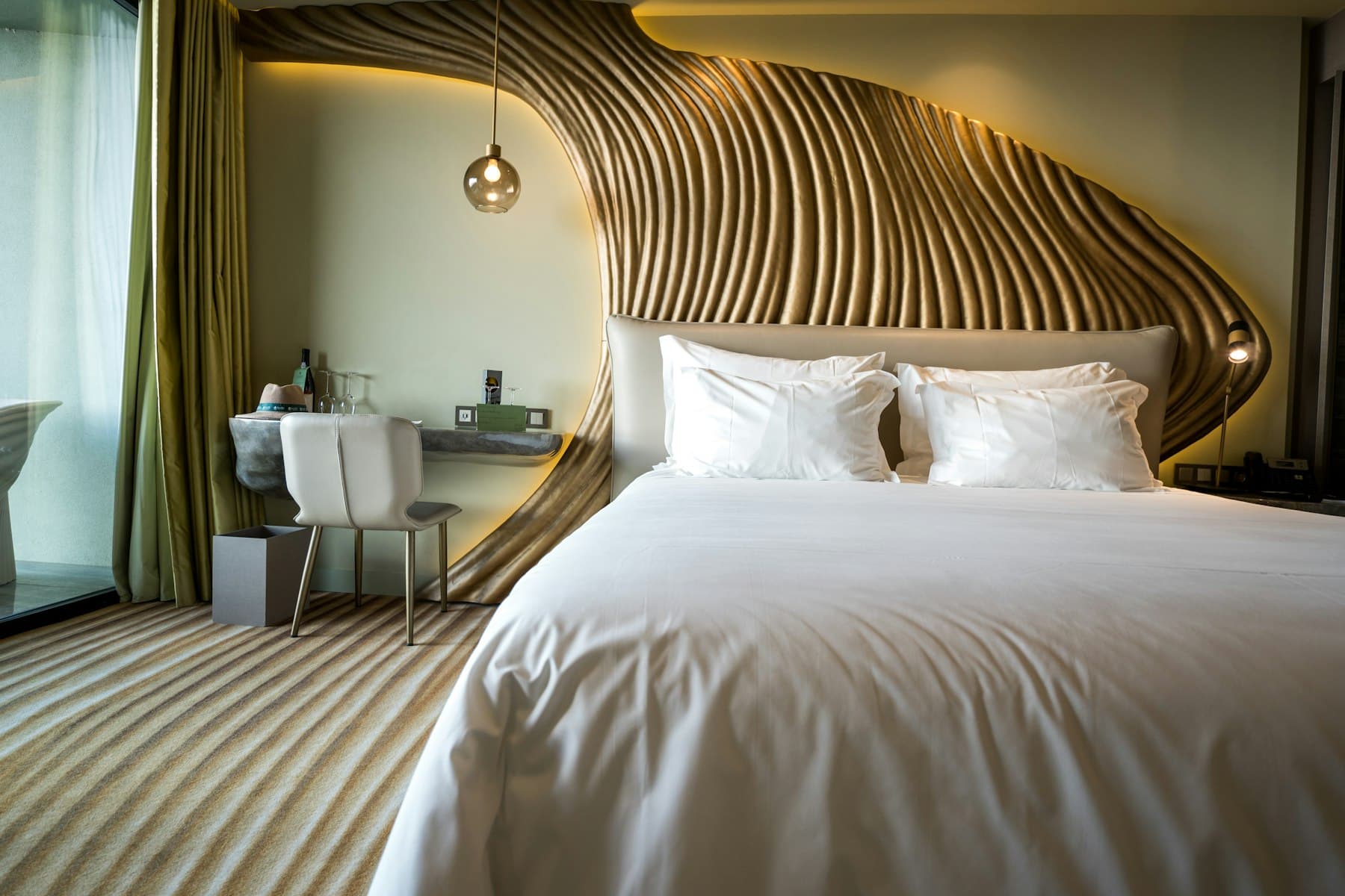 A plain, well-kept room with a wooden headboard and white linen