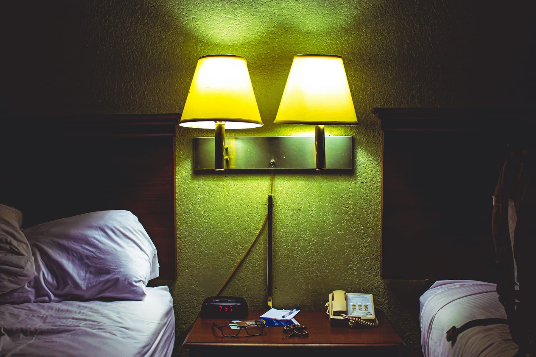 A family room with two beds and a nightstand between them
